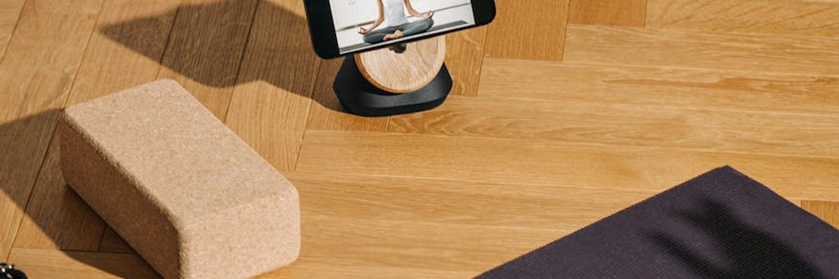 Sunlight hitting a yoga mat on a wooden floor.